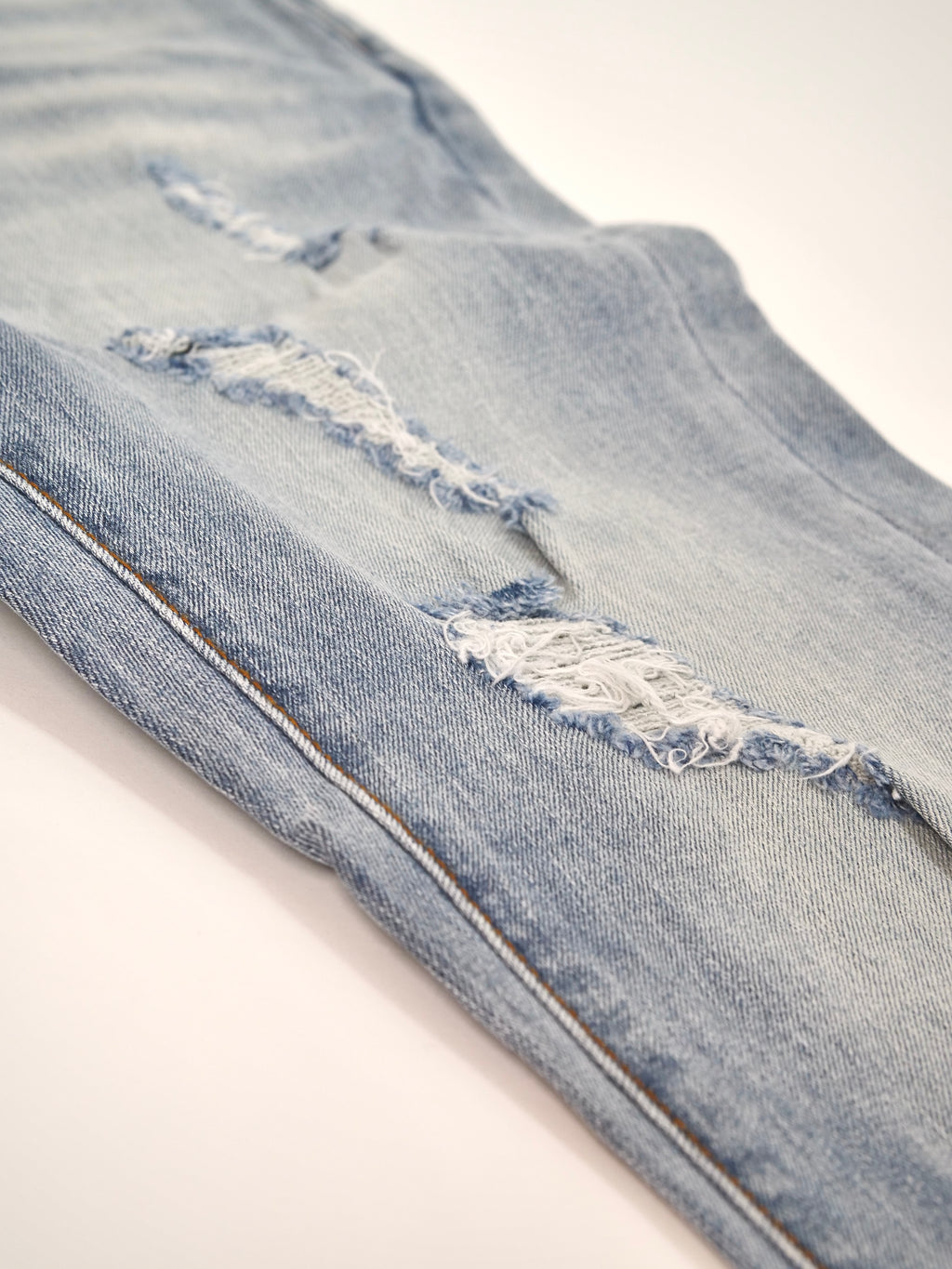 Light Wash Distressed Denim (Slim Tapered)